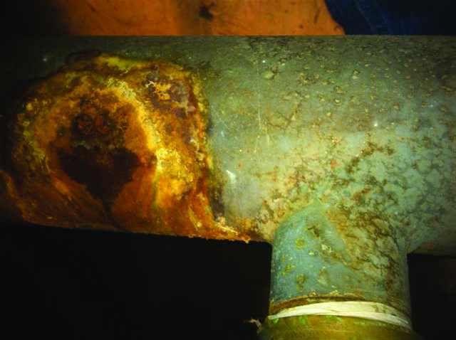 Image of acidic condensate corroding water heater